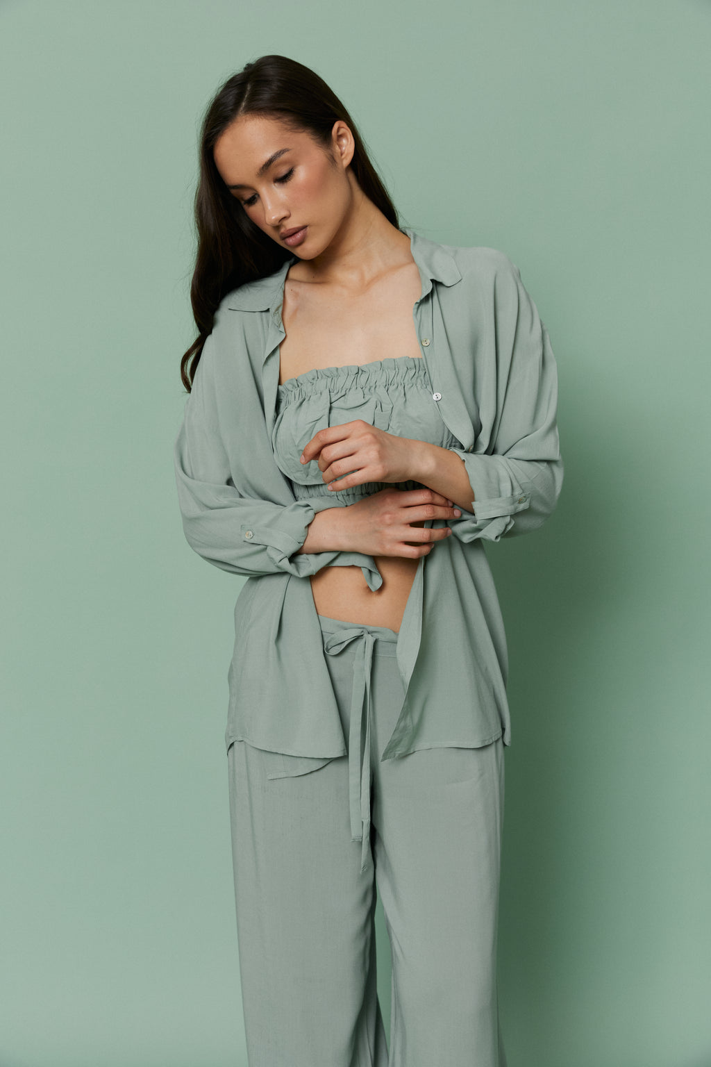 Full-length front view of model in Azalea Green Voile Shirt knotted at the waist, displaying fluid drape and effortless loungewear silhouette.