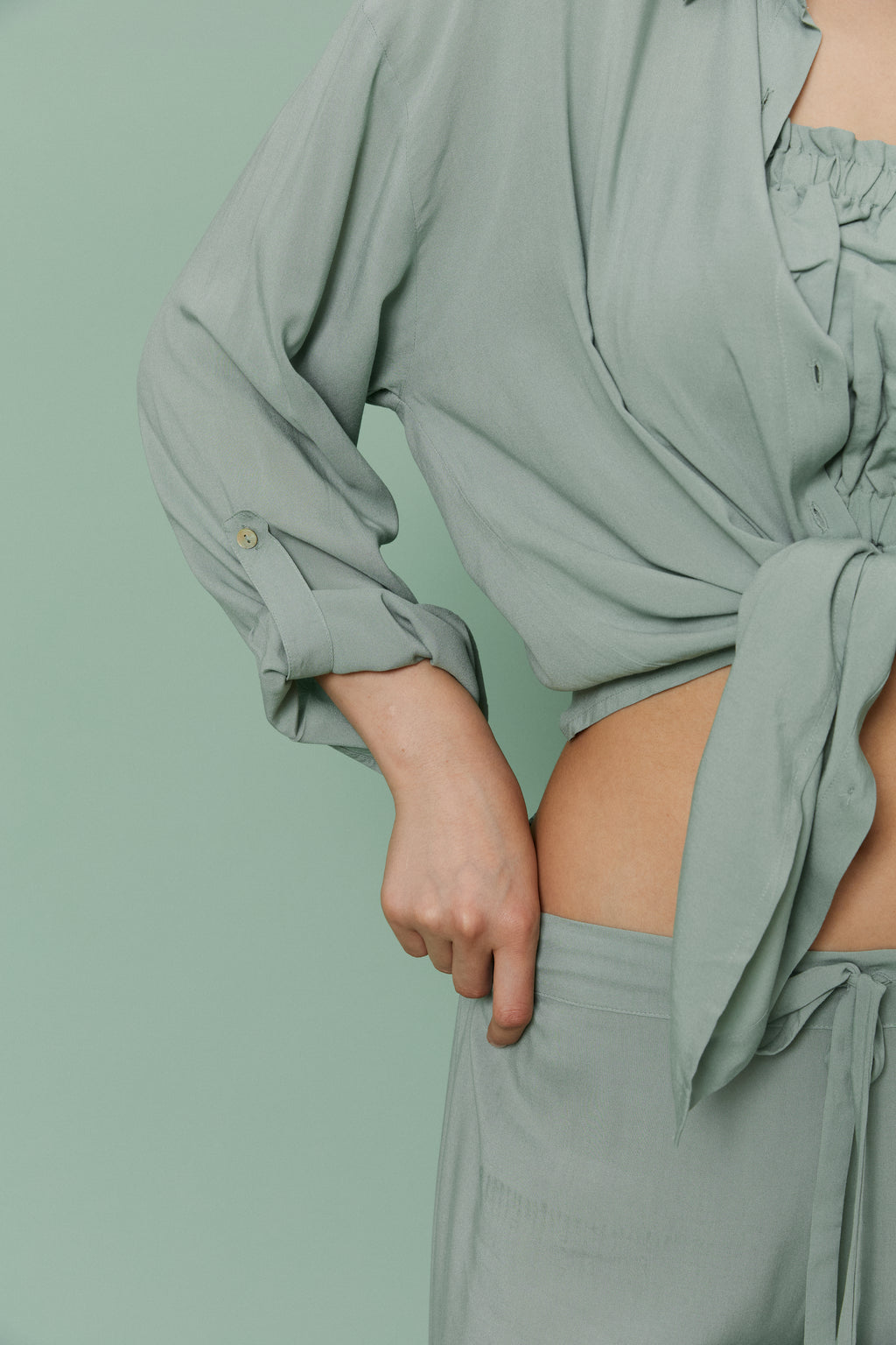 Side view of model wearing Azalea Green Voile Shirt tied at the front, emphasizing airy voile fabric and cropped relaxed styling.