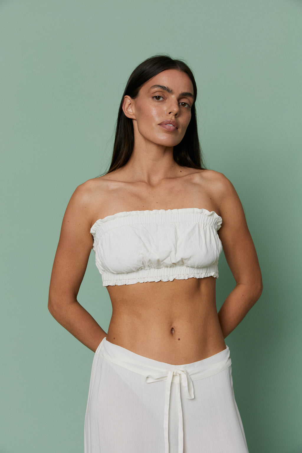 Full-length front view of model in Azalea White Voile Crop top with matching pants, showcasing relaxed strapless silhouette and breathable voile material.