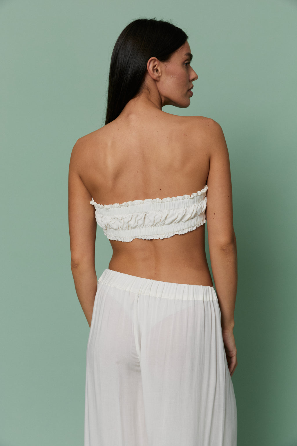 Back view of model wearing Azalea White Voile Crop top, displaying ruched back detail and airy sheer voile fabric.