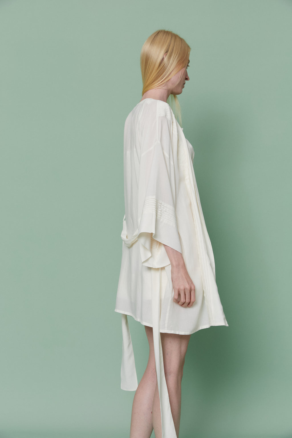 Side profile of model in Azalea White Voile Kimono Robe, illustrating graceful drape, wide sleeves and lightweight breathable movement.