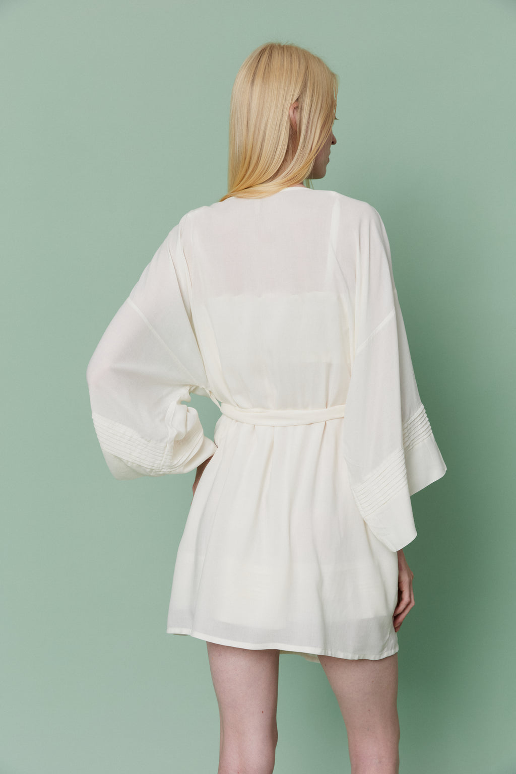 Back view of model wearing Azalea White Voile Kimono Robe, highlighting wide flowing sleeves and elegant tie-back waist detail.