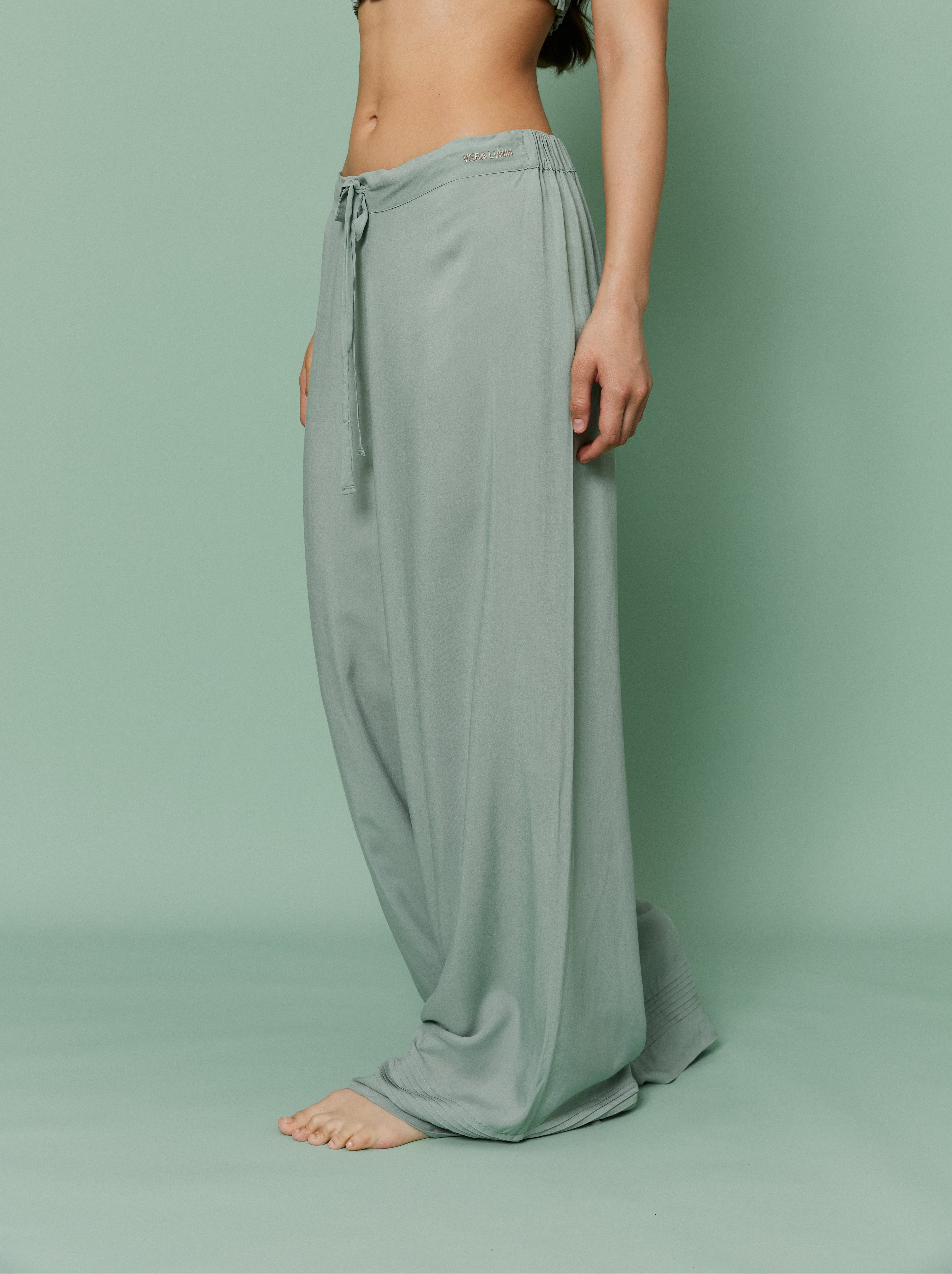 Model wearing Azalea Green Voile Lounge Bottom, showcasing low-rise fit, wide-leg silhouette and lightweight sheer voile fabric.